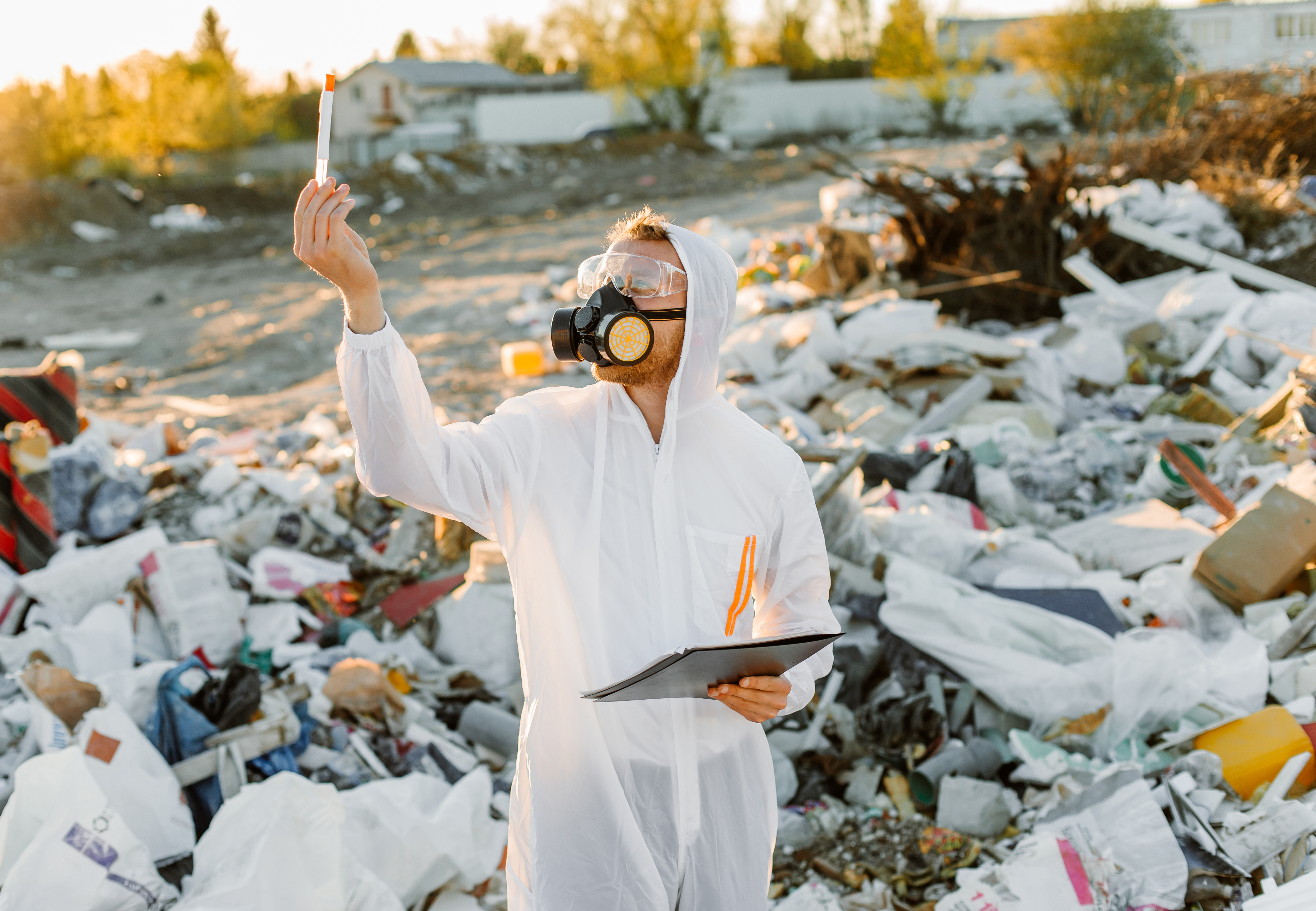 man in landfill checking for contaminated items