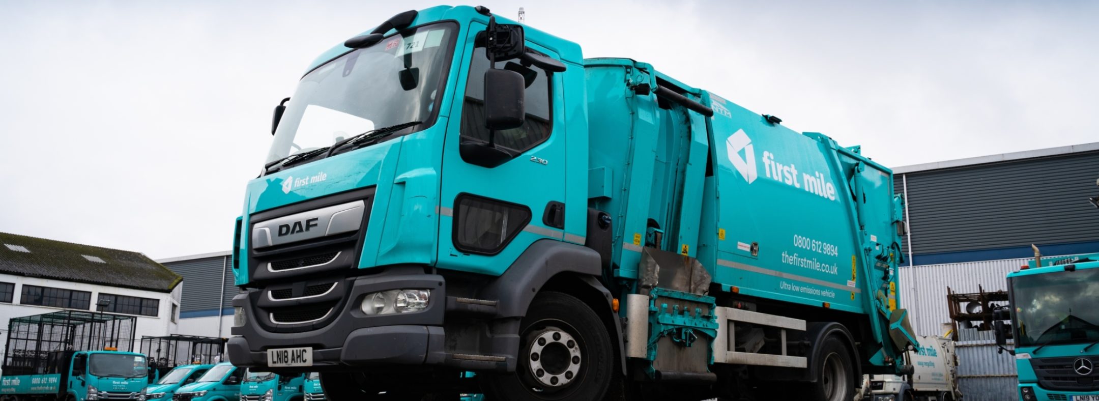 A parked blue truck with First Mile branding