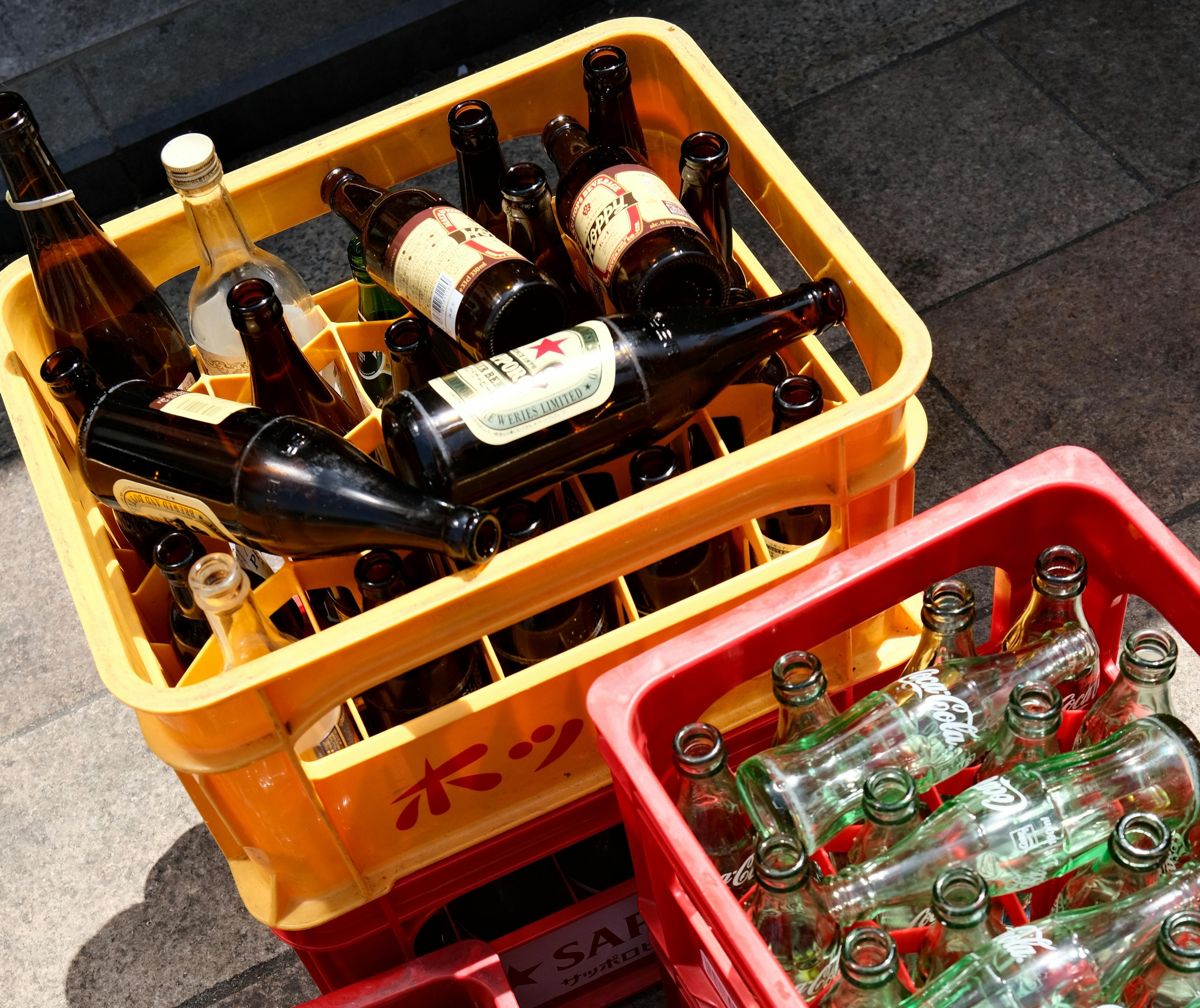 empty beer bottles inside a plastic crate