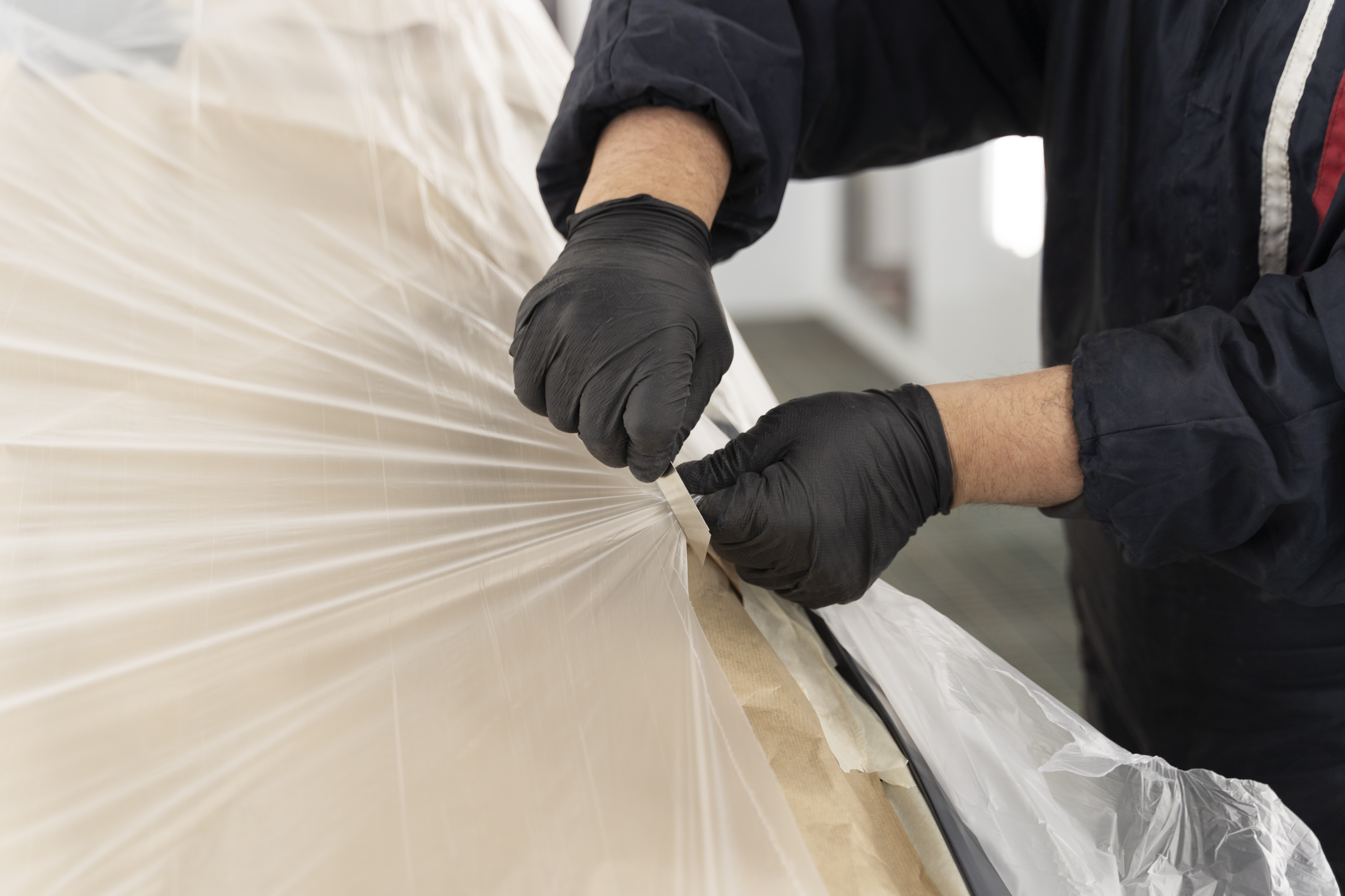 service worker covering item with shrink wrap and collation film