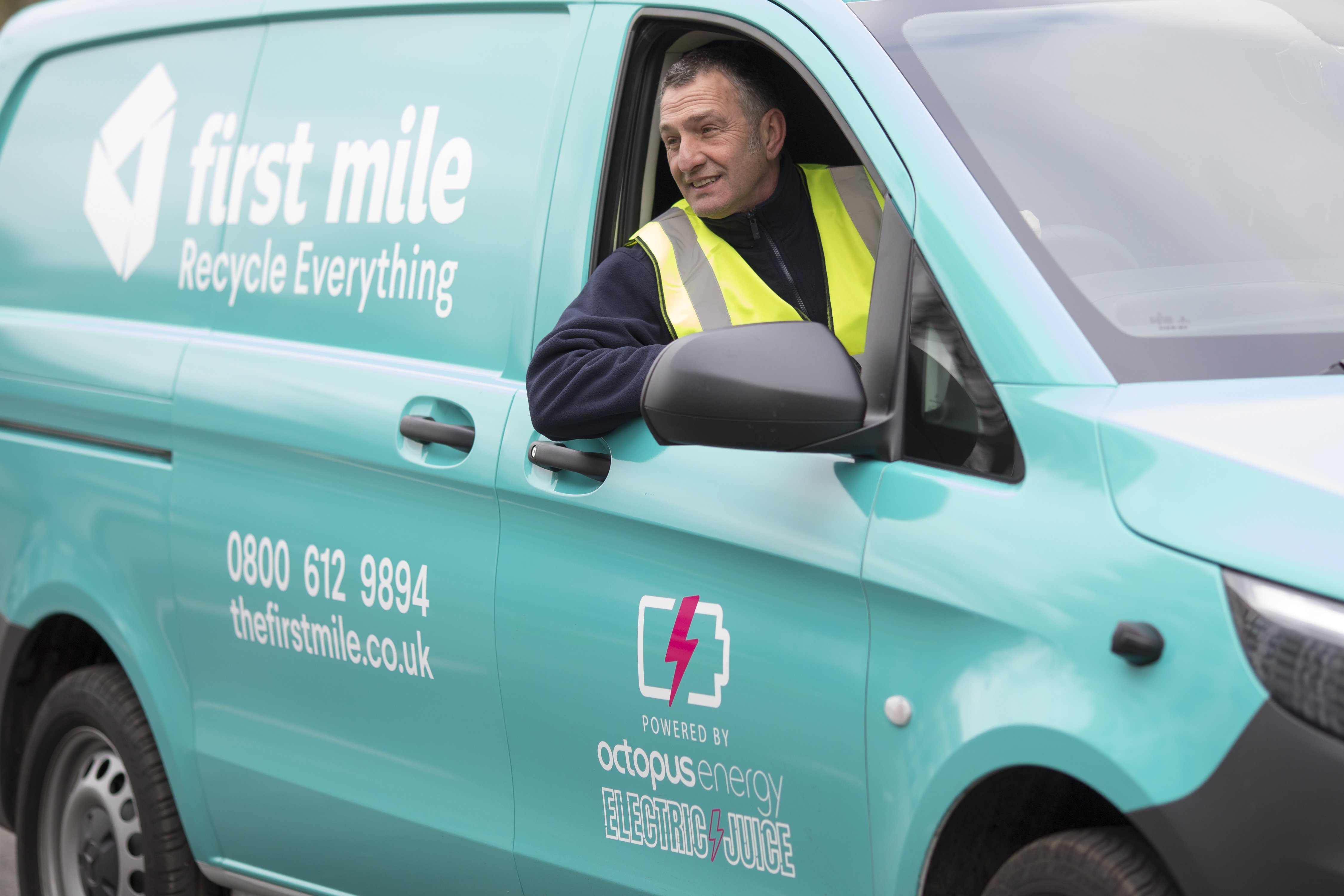 Man inside a First Mile van, with emphasis on the powered by octopus energy sticker