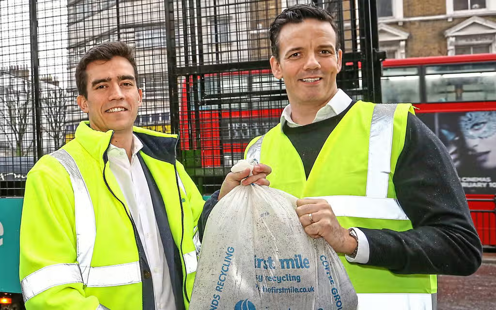 Workers outside with a First Mile bag