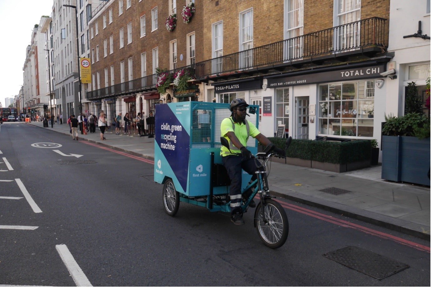 Street view of Baker Street with a man on a first mile collection bike