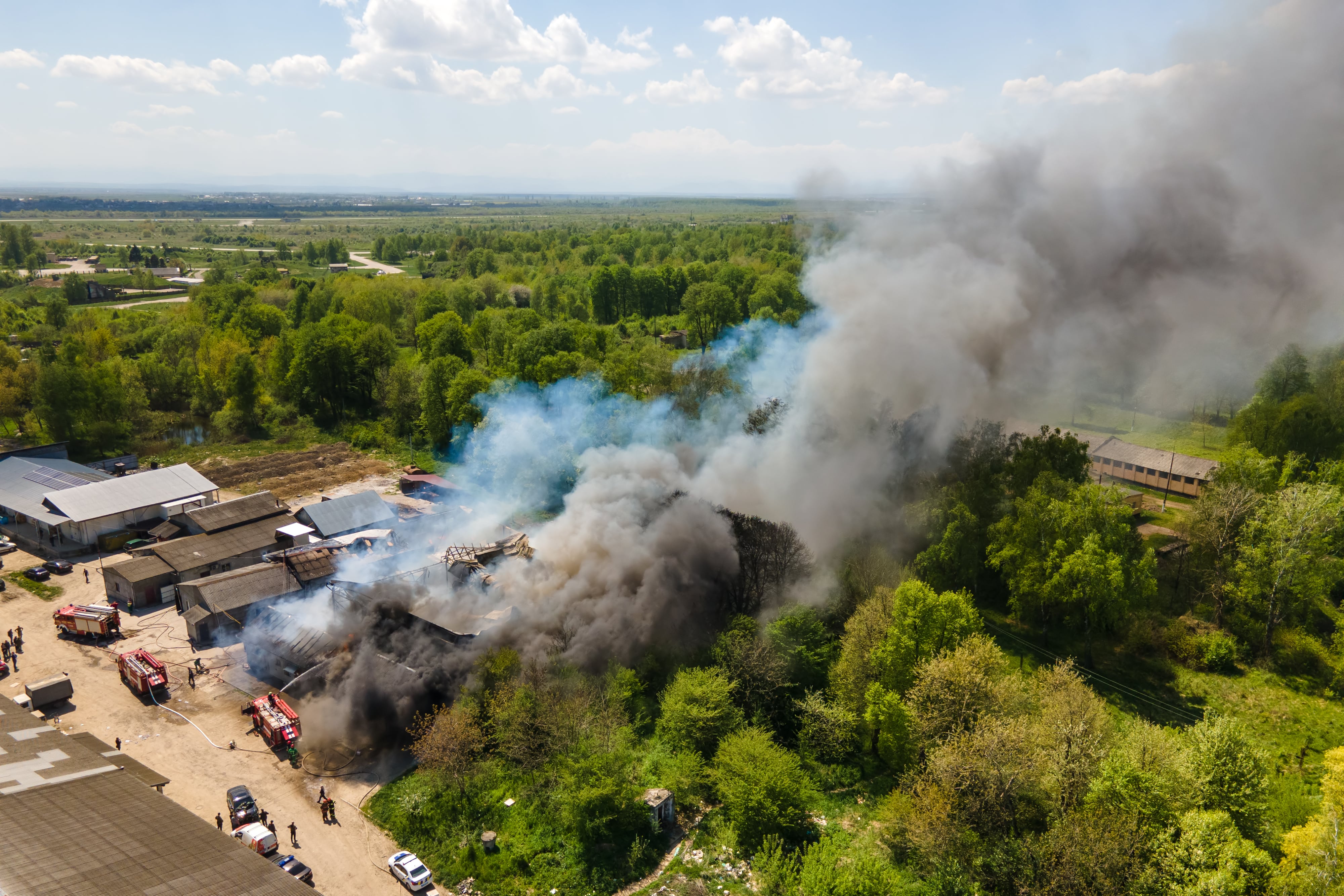 Aerial view of firefighters extinguishing a ruined building after a fire