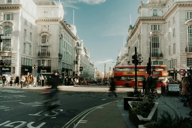 A picture of Oxford Street with blurred people and busses.