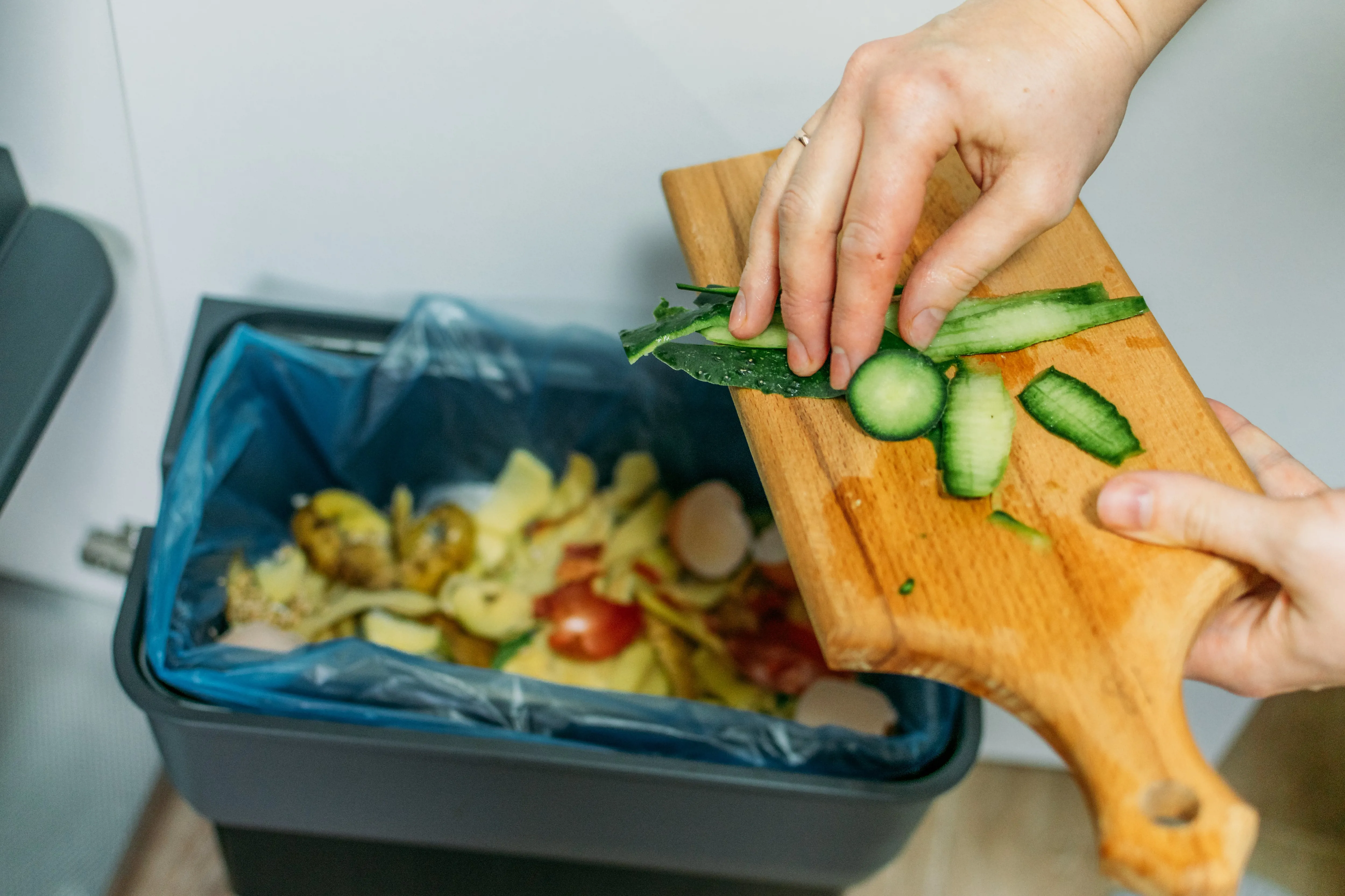 food being placed into a food recycling bin