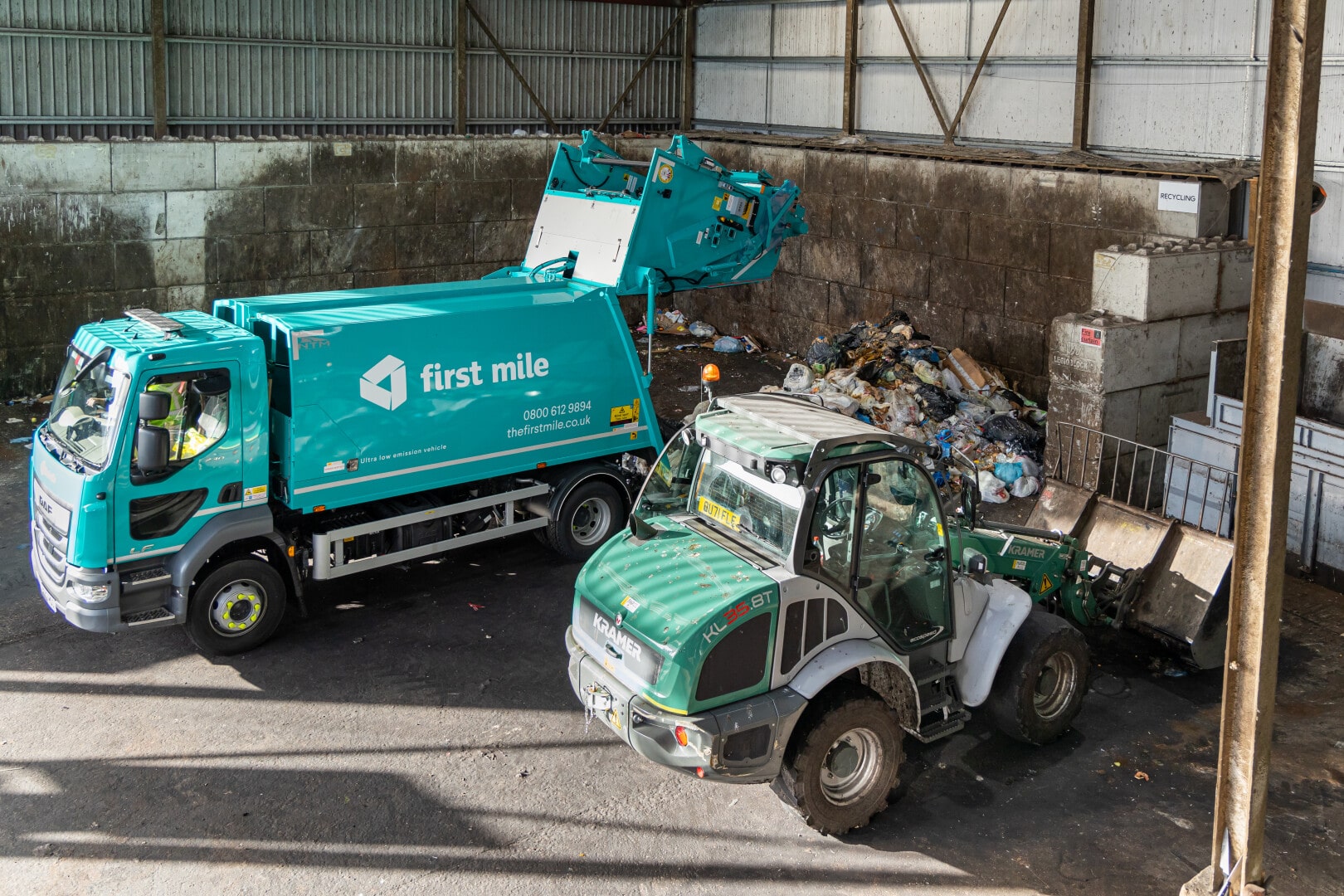 First Mile compactor van and forklift emptying van on site