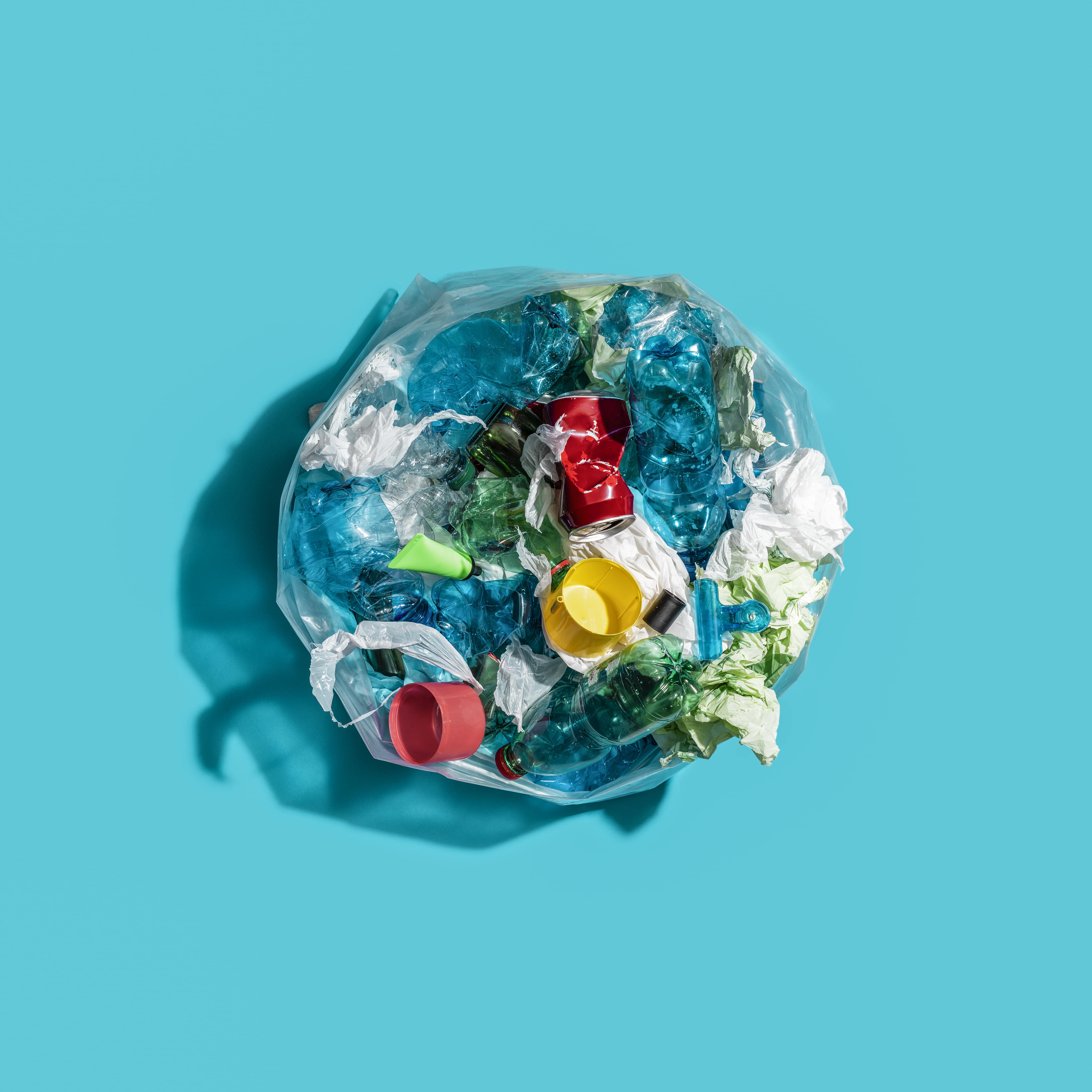 Garbage bin filled with mixed waste and plastic items