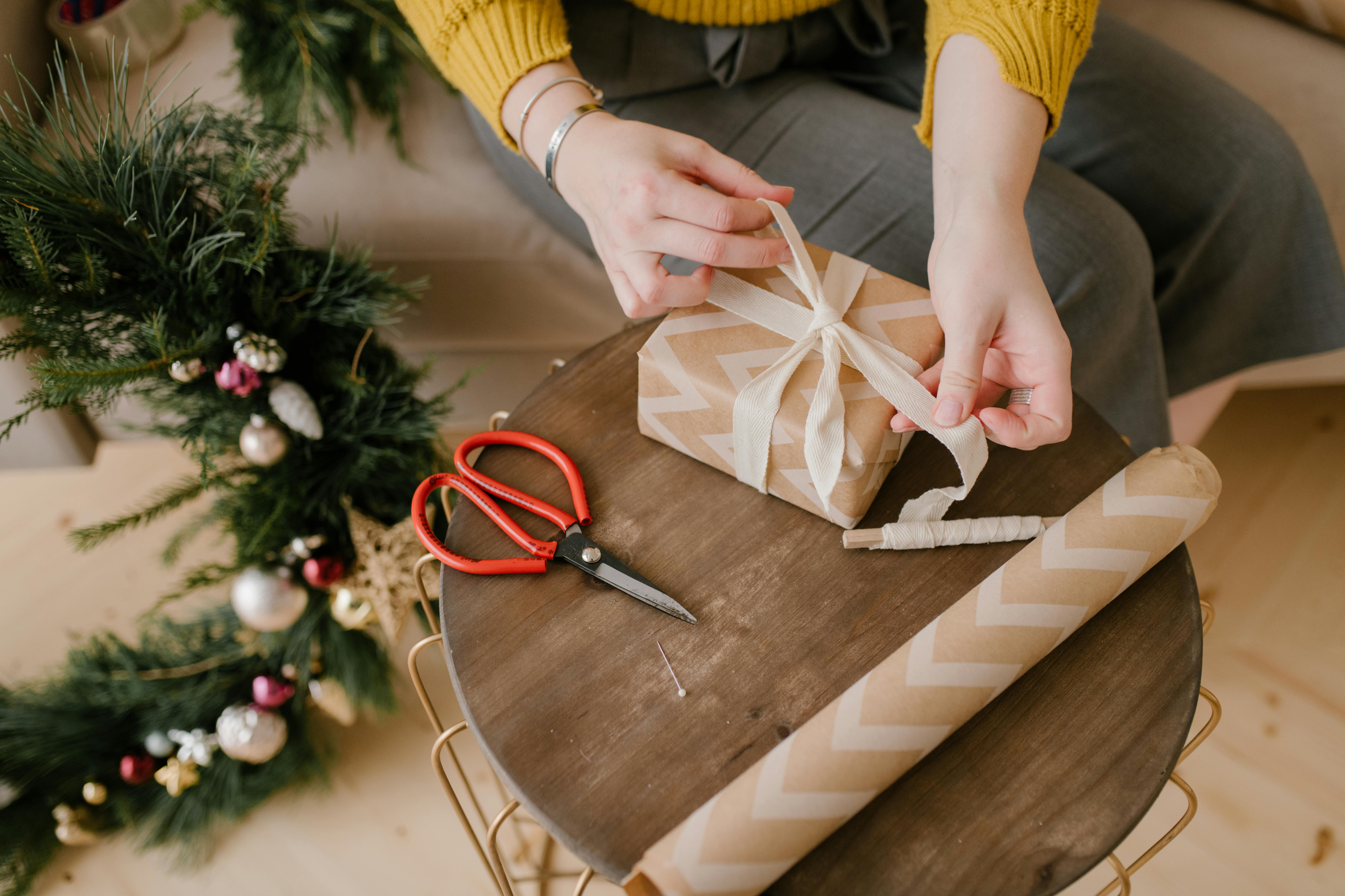 Close-Up Shot of a Person Wrapping a Gift