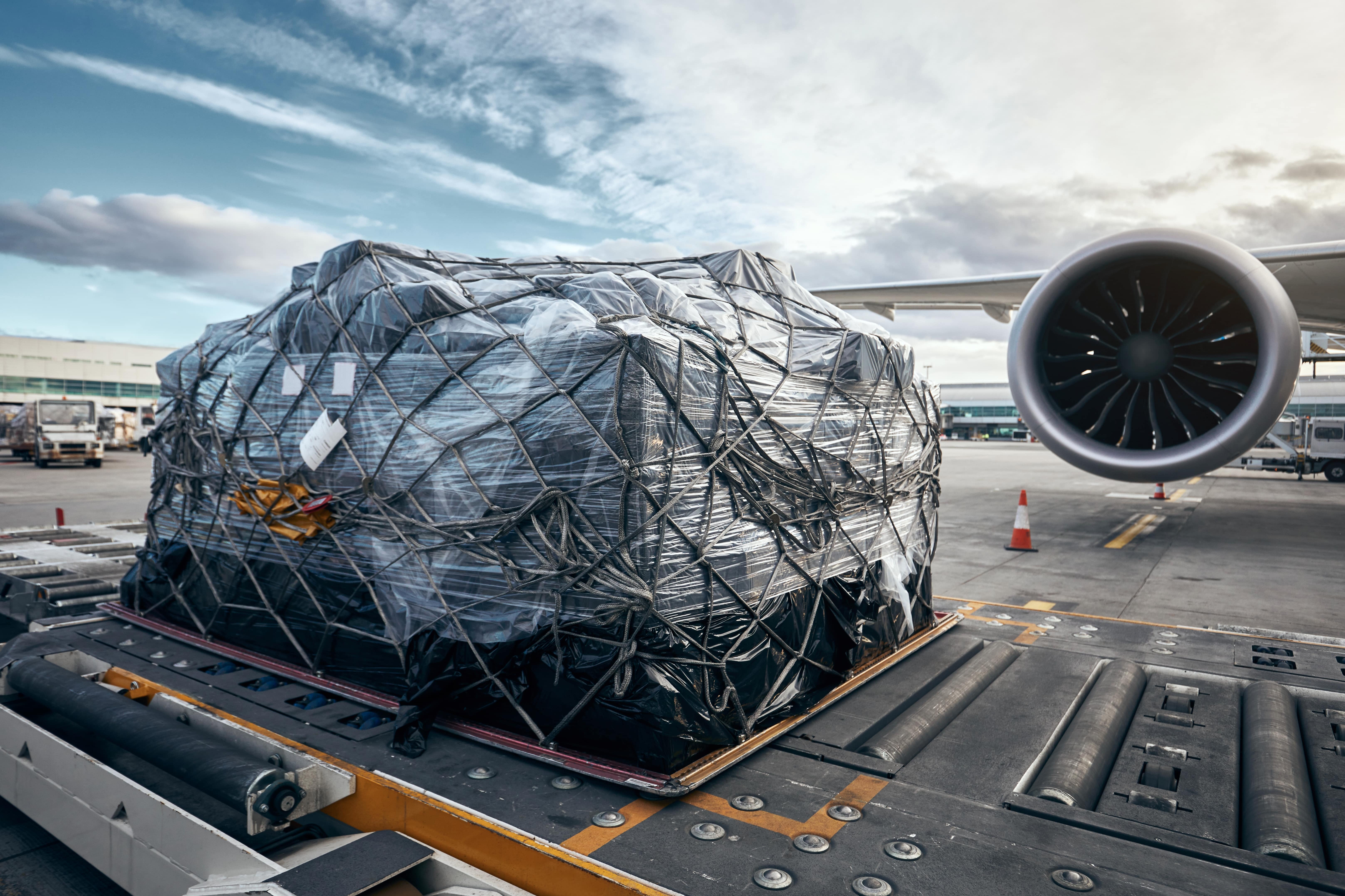 Preparation of cargo loading into a container before a flight at a busy cargo terminal
